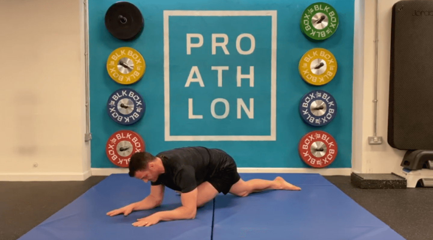 A man demonstrates a hip mobility stretch