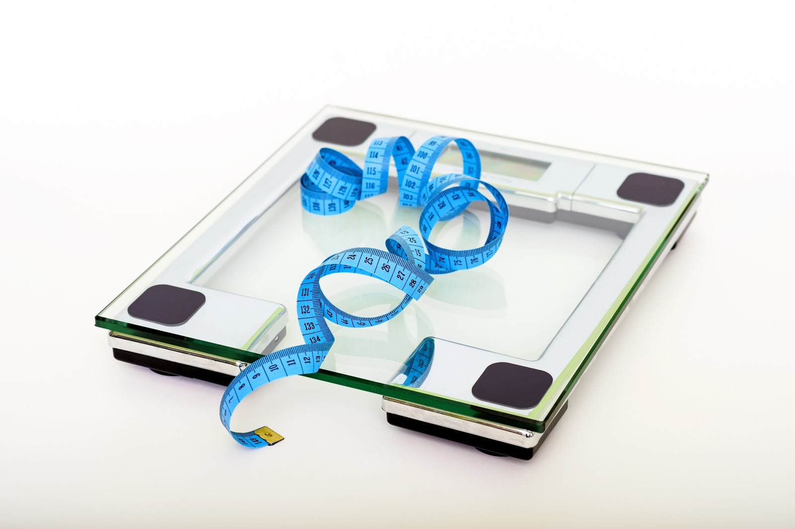 Two weight loss tools to use at home - a tape measure and a set of bathroom scales
