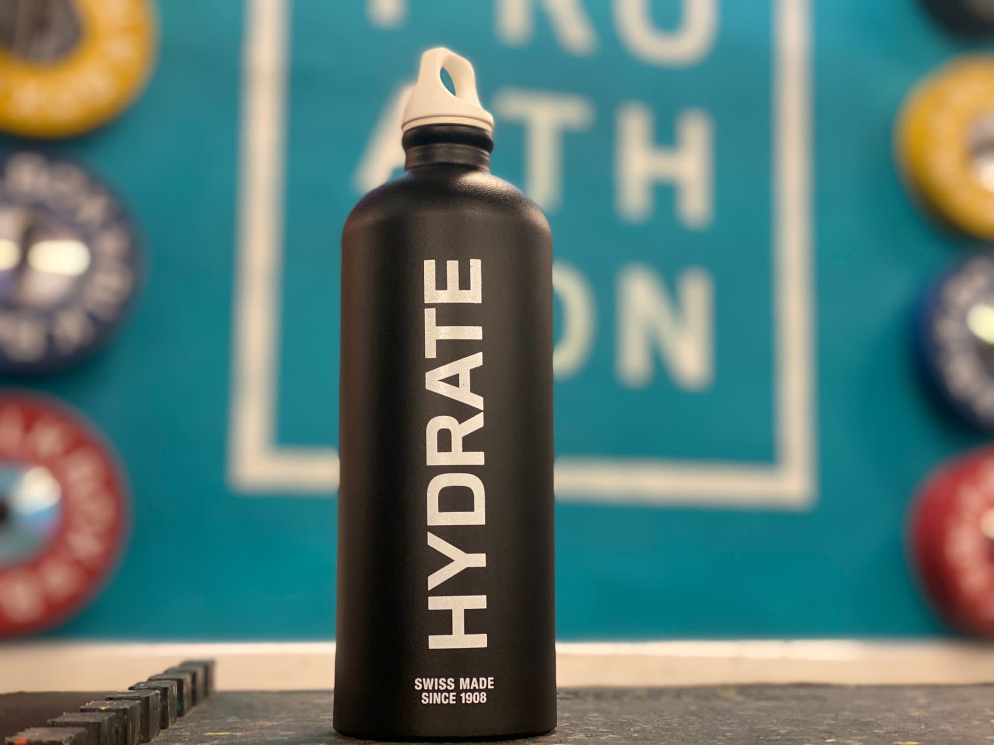 A reusable water bottle with the word Hydrate written on it.