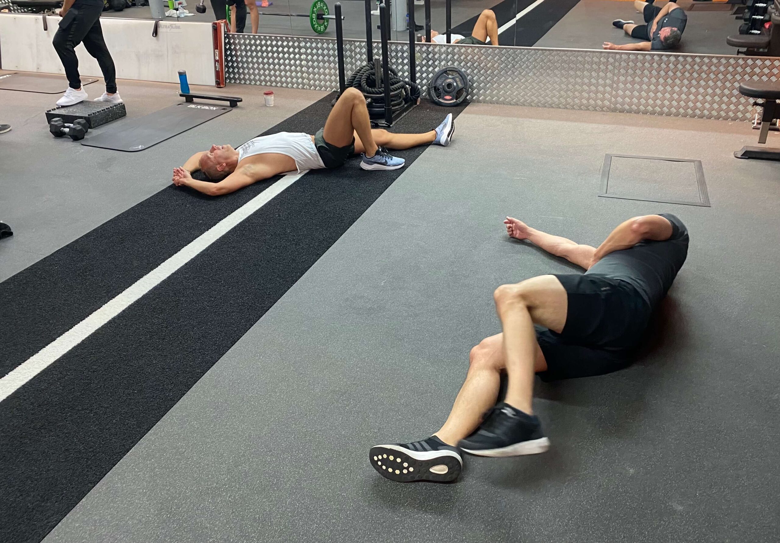 2 men lying down after training